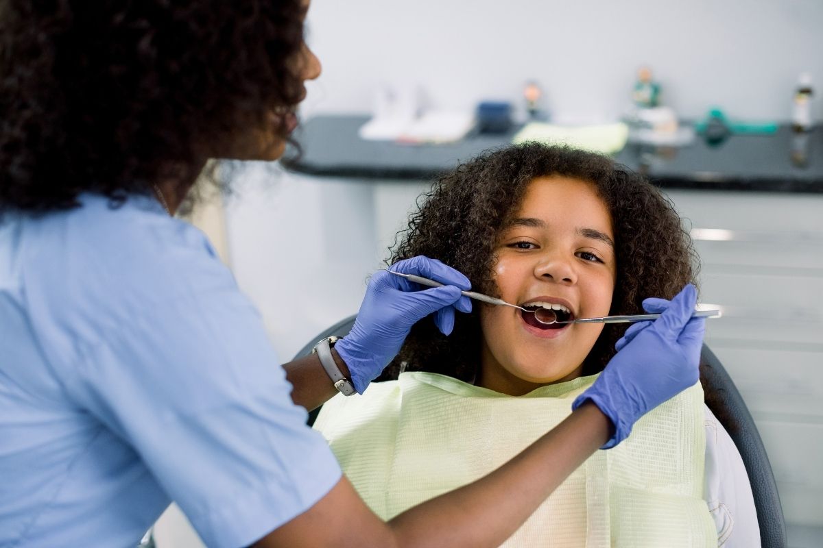 dentist checking teeth of kid